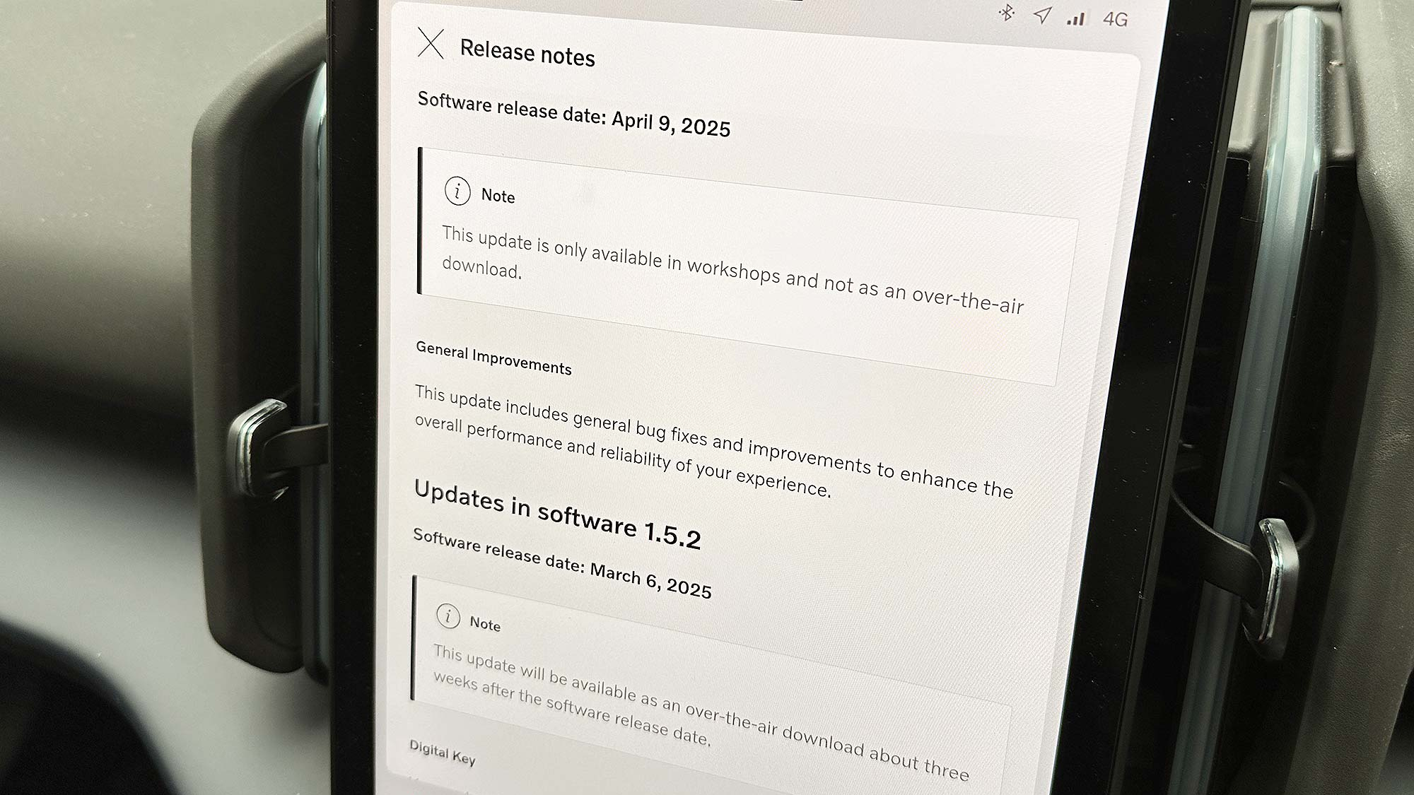 A close-up of a car's in-dash screen showing software release notes dated April 9, 2025. The note states that the update is only available in workshops and not as an over-the-air download.