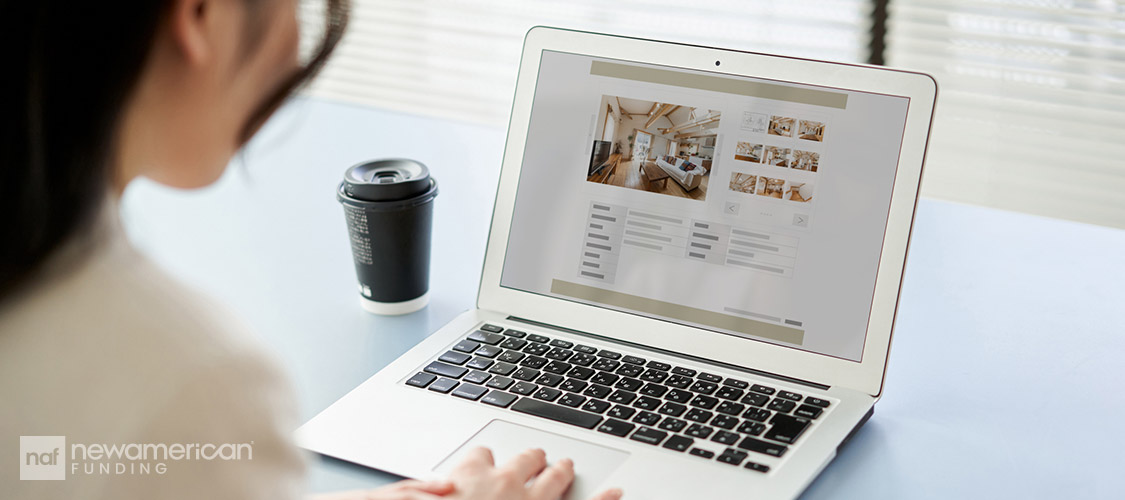 woman looking at real estate property on her laptop