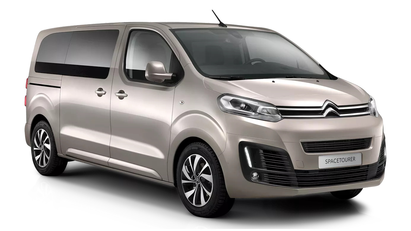 Front-side view of a beige Citroën SpaceTourer MPV featuring stylish chrome accents, curved body lines, and dual sliding side doors.