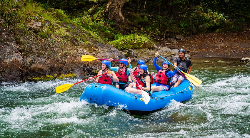 A group of Road Scholars gleefully white-water rafting in Costa Rica