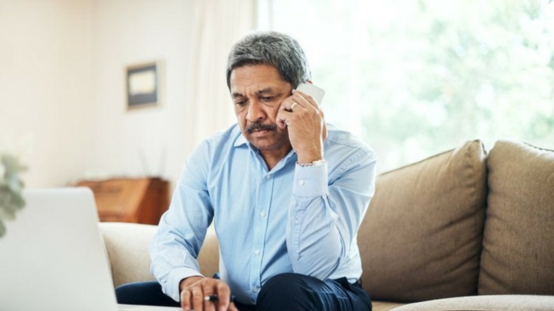 Hispanic man on phone.jpg