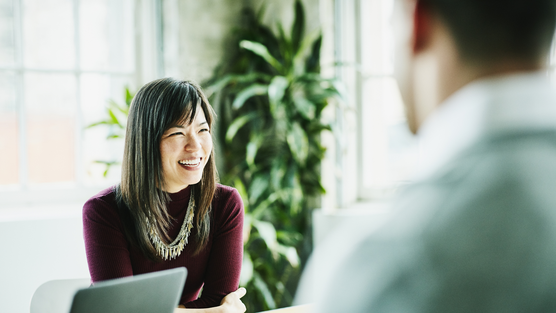 Smiling businesswoman leading project meeting in office conference room