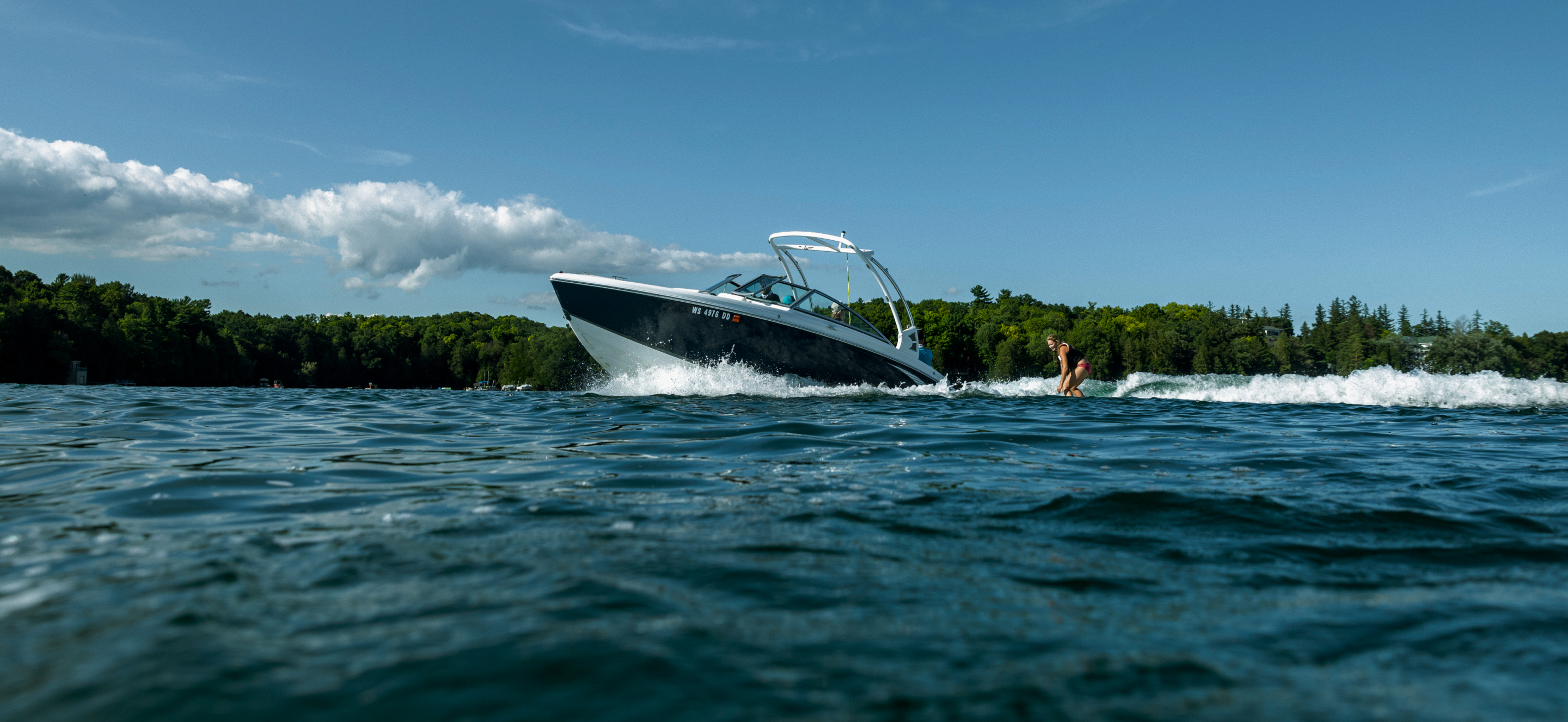 A water-skier being pulled by a speedboat