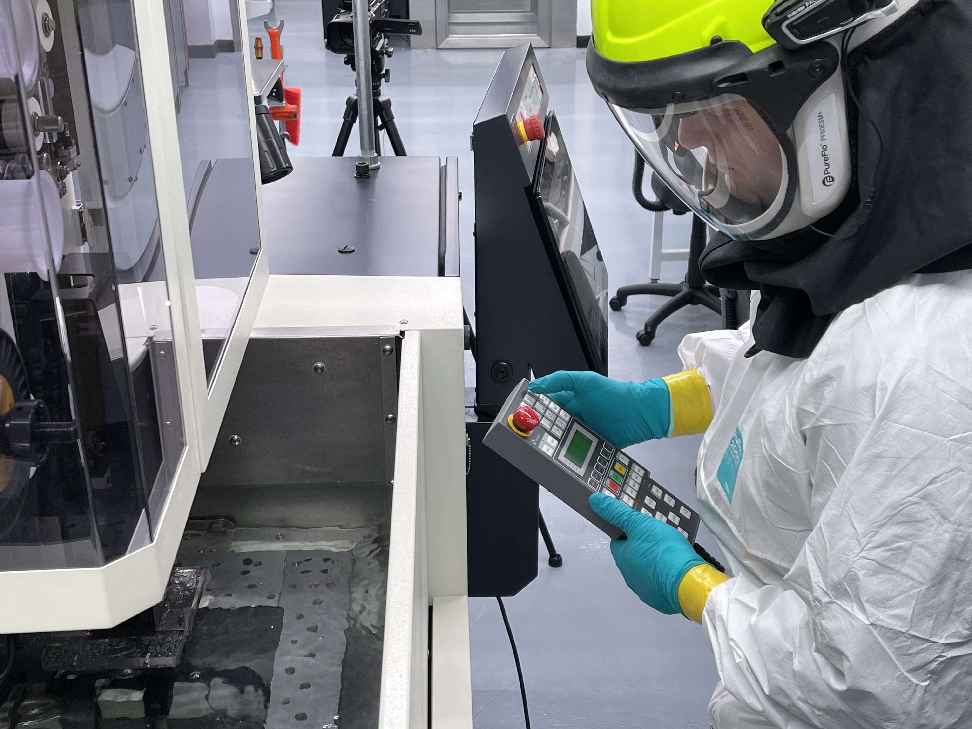 Employee at Materion's additive lab wearing safety gear and working with 3D printer