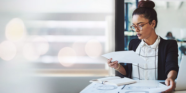 woman looking over paperwork