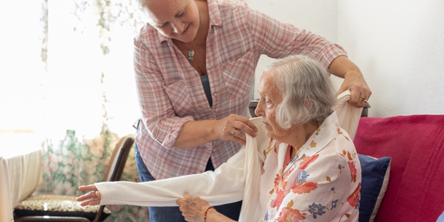 Mature woman caring for her elderly mother