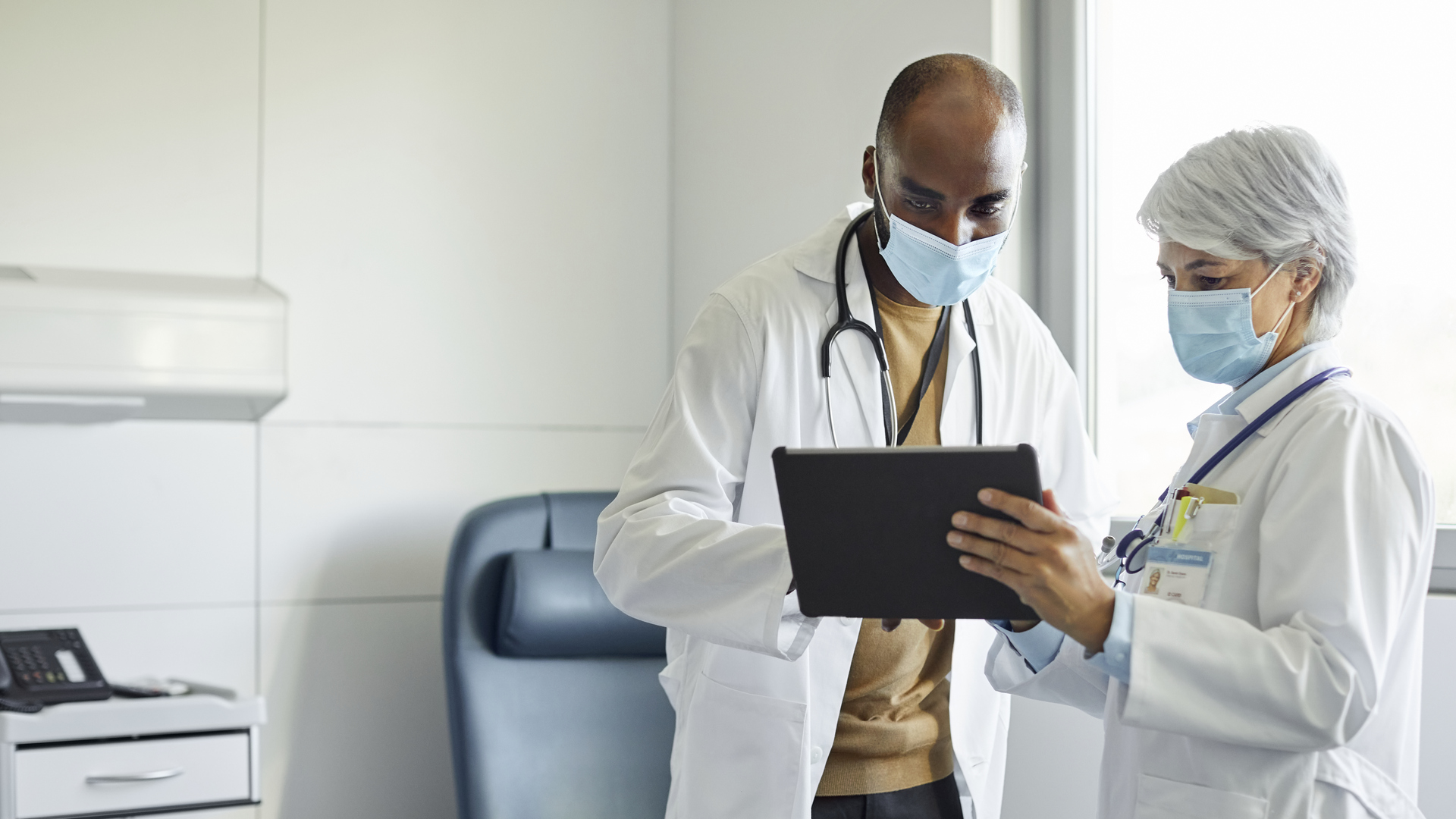 Medical workers with digital tablet in hospital