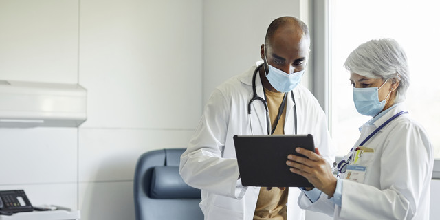 Medical workers with digital tablet in hospital