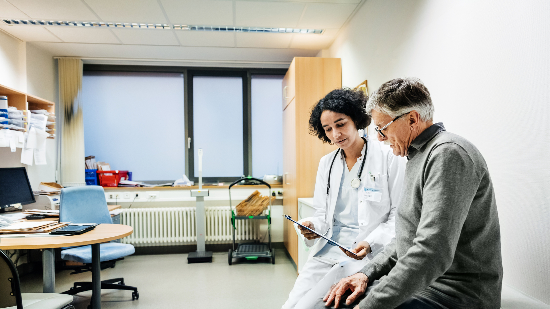 Elderly Man Talking To Doctor About Test Results