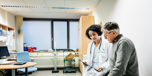 Elderly Man Talking To Doctor About Test Results