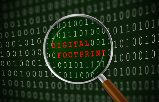 Number codes on a digital screen with a maginifying glass hovering over the words 'digital footprint'