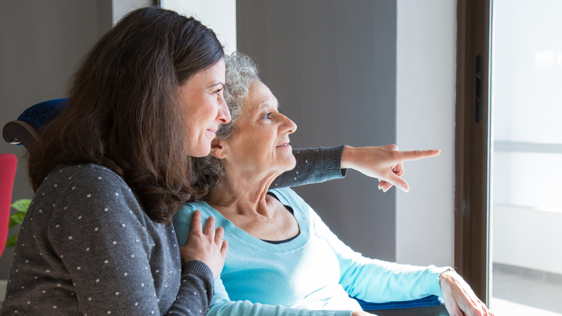 Happy senior mother and adult daughter enjoying dramatic view