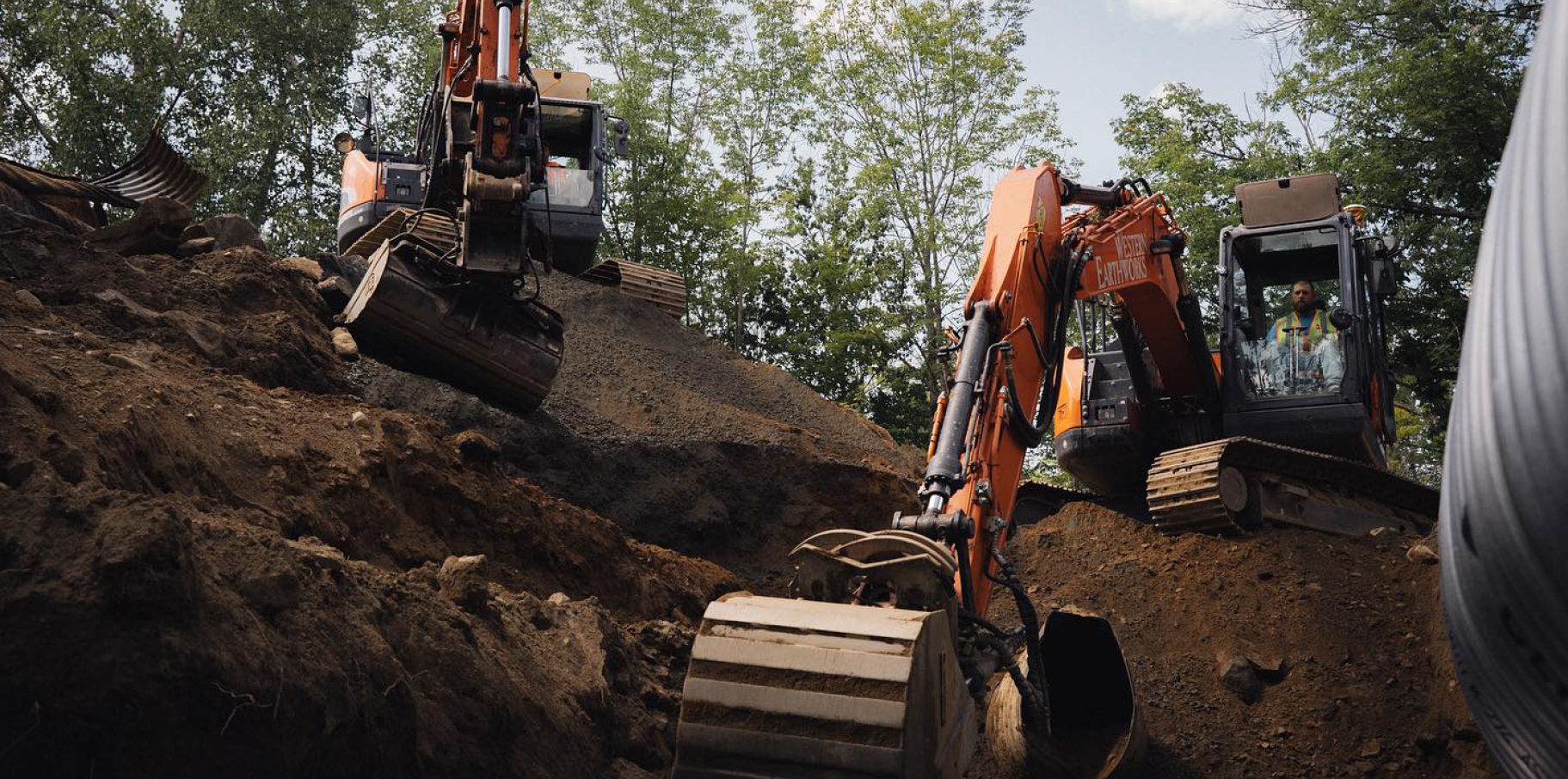 Two DEVELON excavators working on a job site.