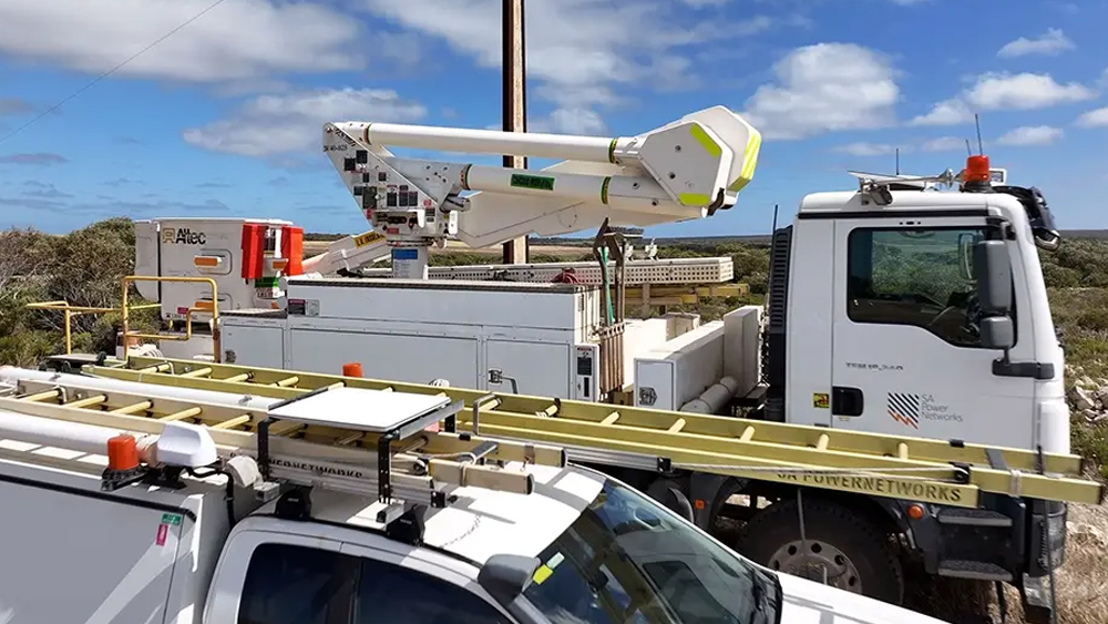 Picture of two SA Power Networks trucks out at work