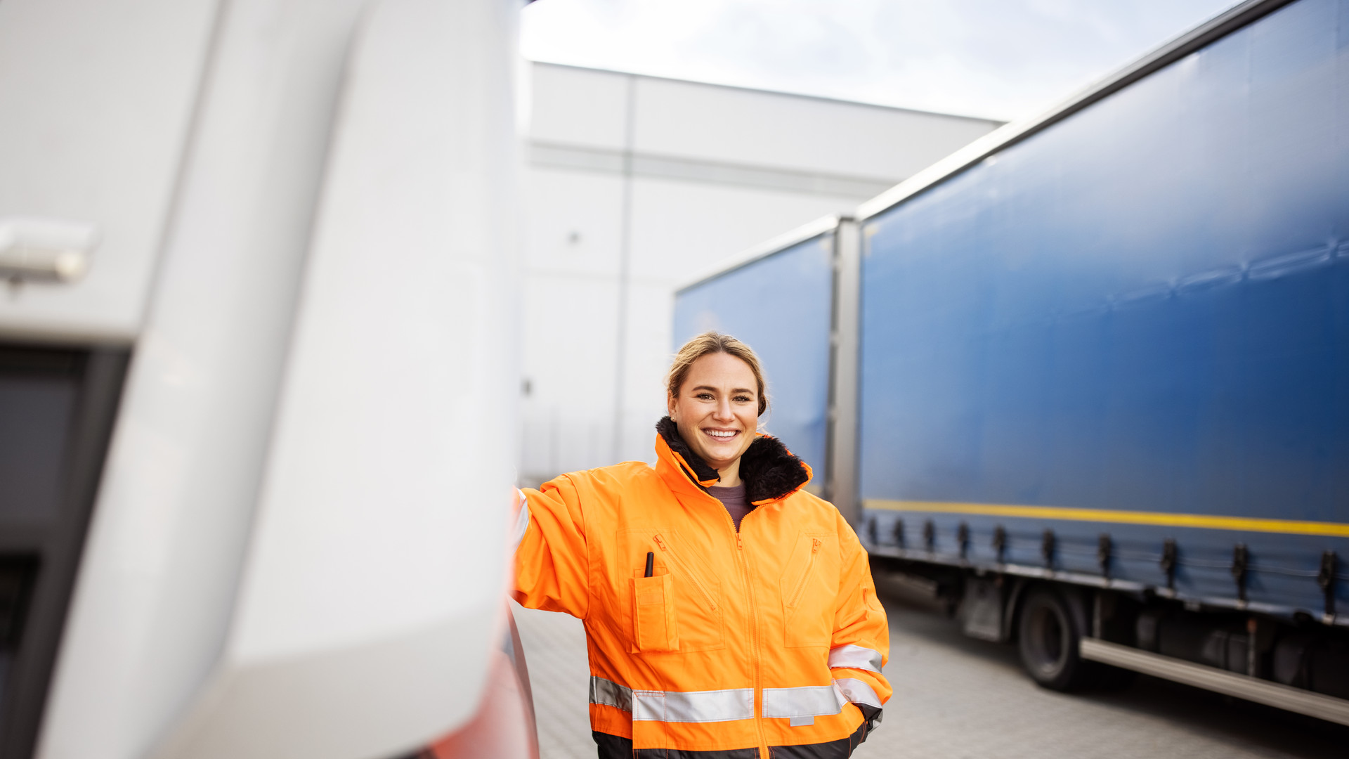 Female transport engineer standing by the truck outdoors