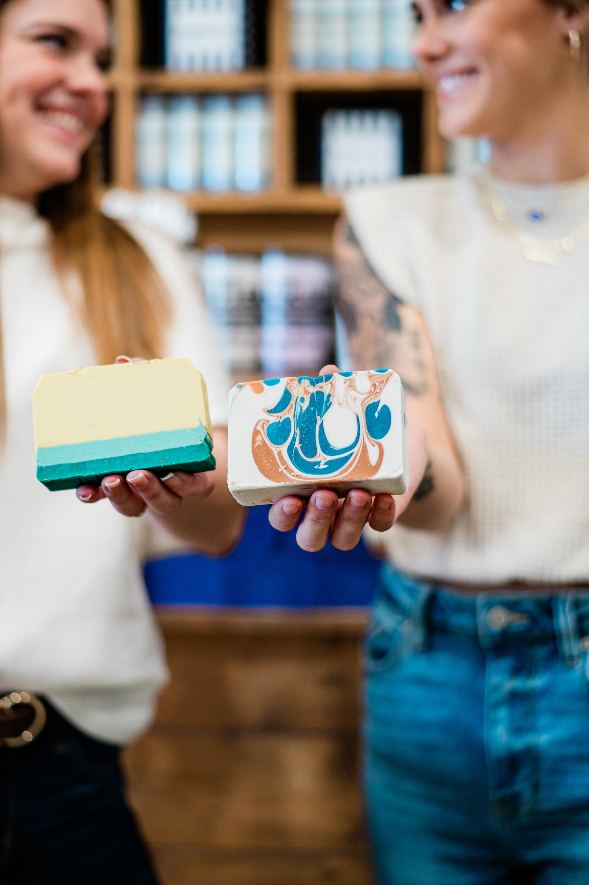 Women hold soaps