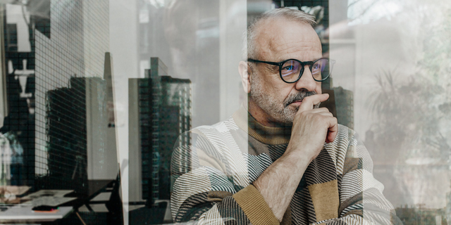 Senior man thinking by window