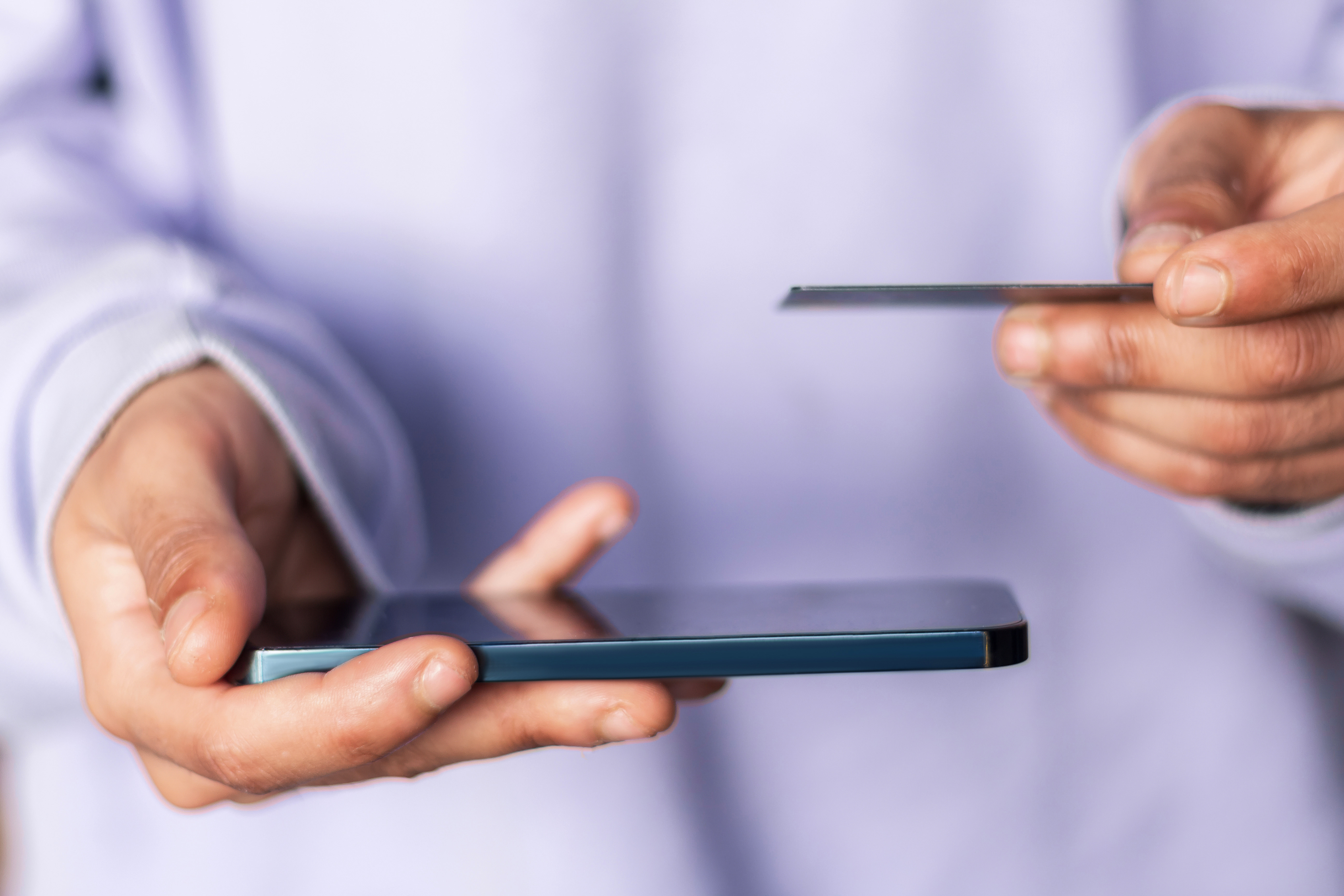 holding debit card and mobile phone