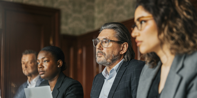 Male and female business professionals attending meeting at office