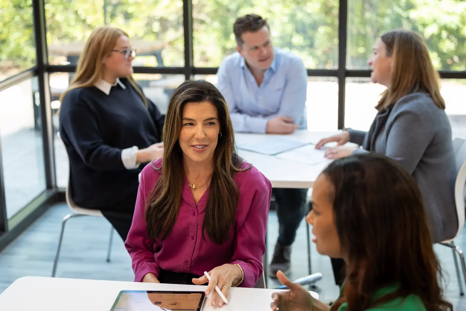 Resource managers discussing real-time resource availability for project planning across multiple projects