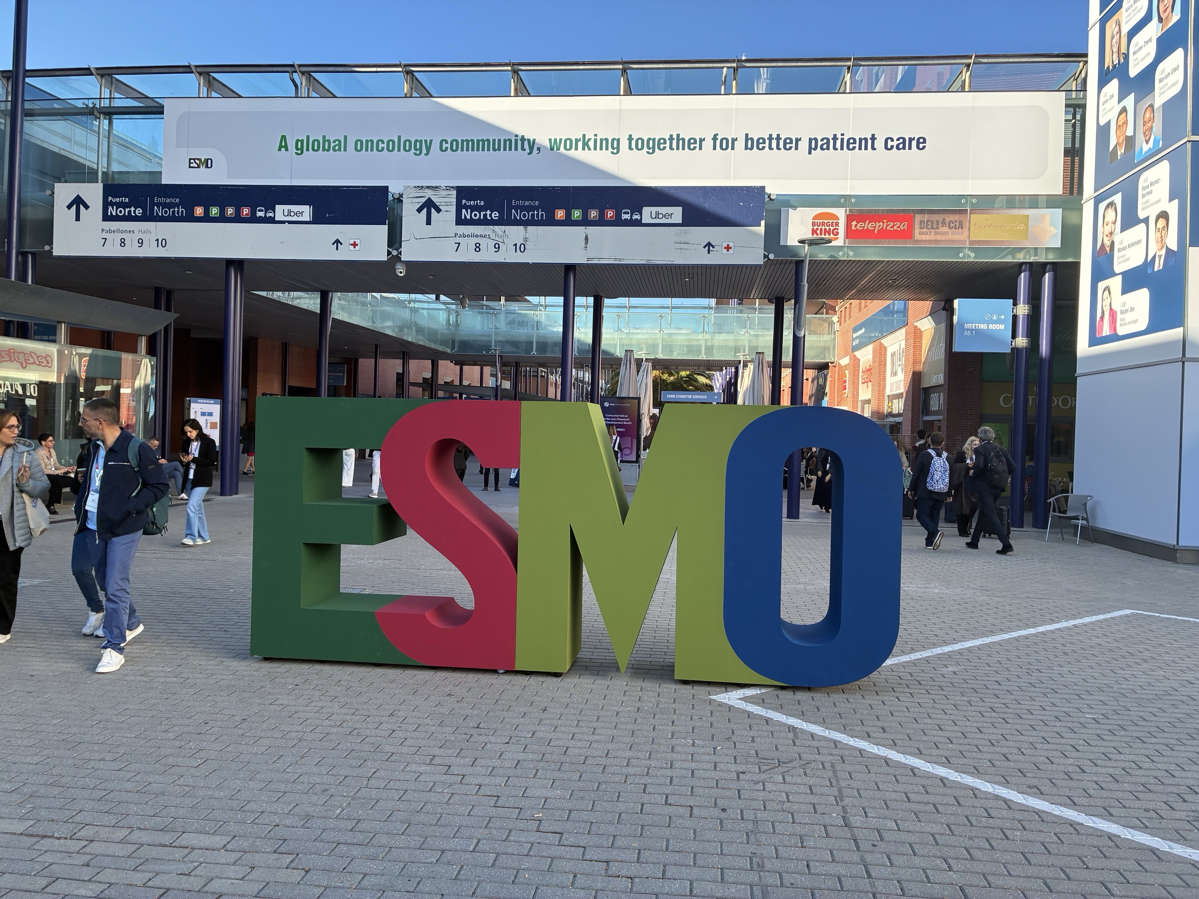 Colorful ESMO logo outside congress venue.