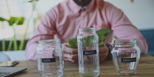 Man Counting Money for Savings, House and Car, Financial Planning Concept