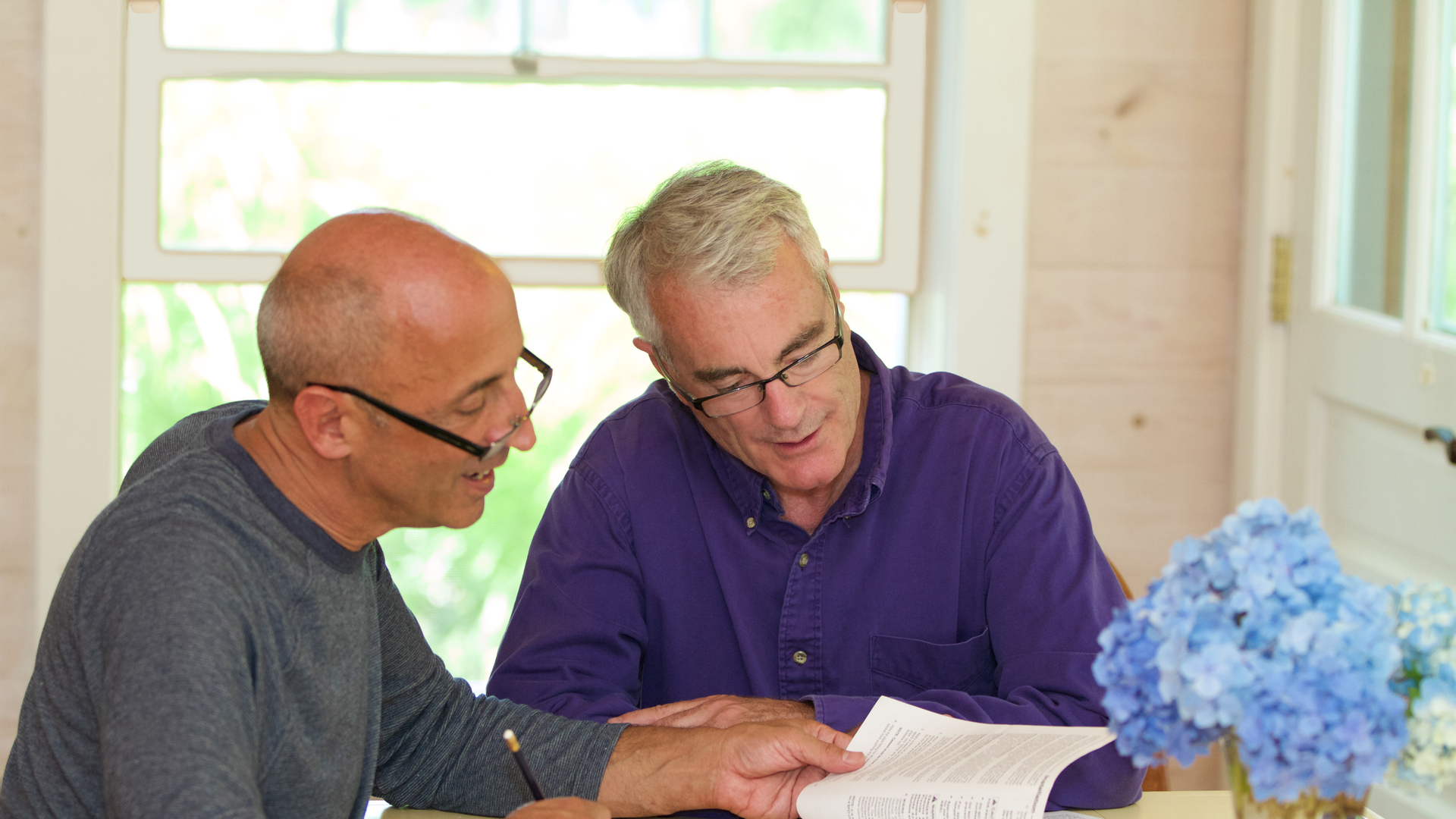 Senior Gay Male Couple Working Together on Financial Documents