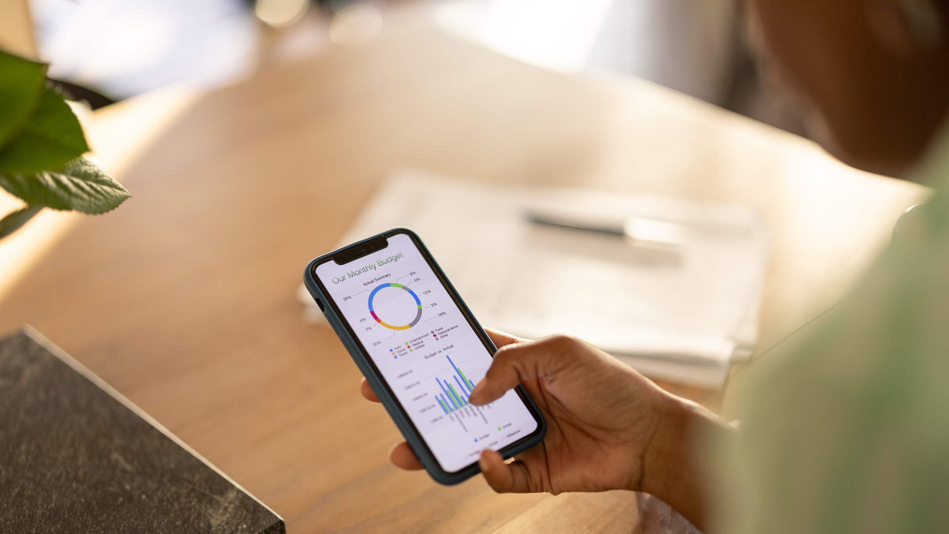 Young woman checking her spending on home finance app