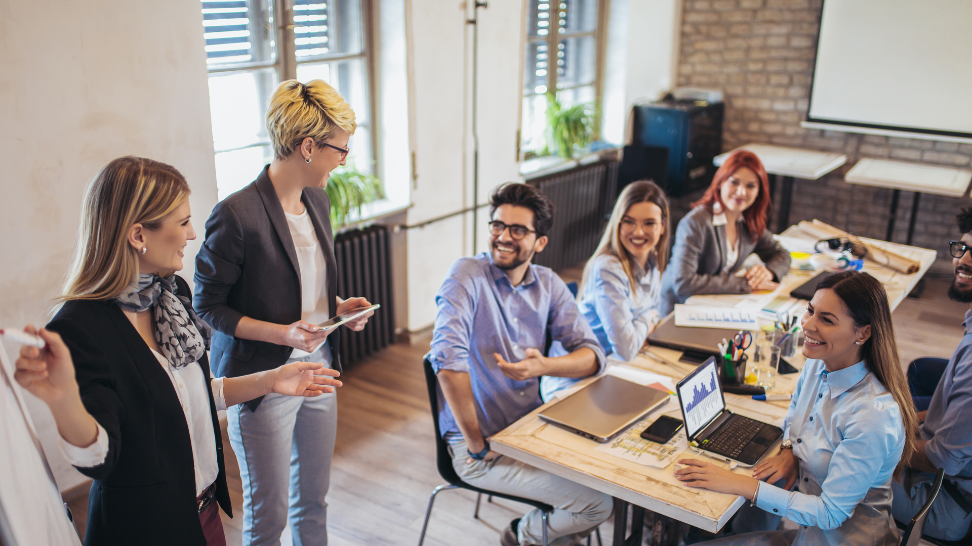 Business colleagues in conference meeting room during presentation