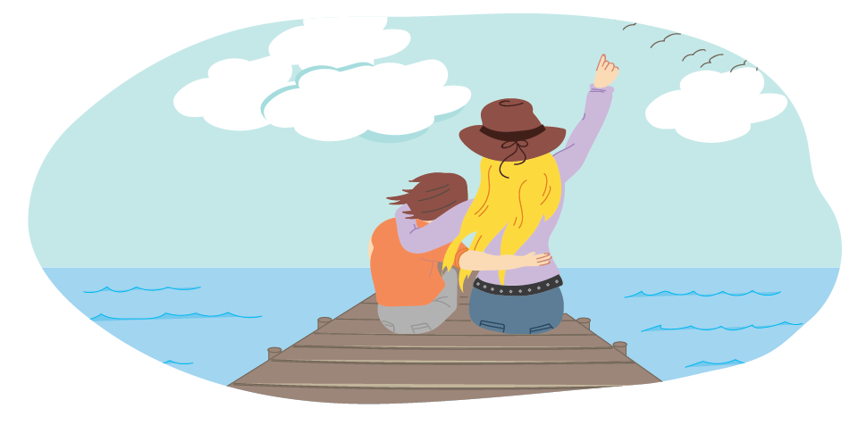 Two people sitting together on a wooden jetty looking out over the water.