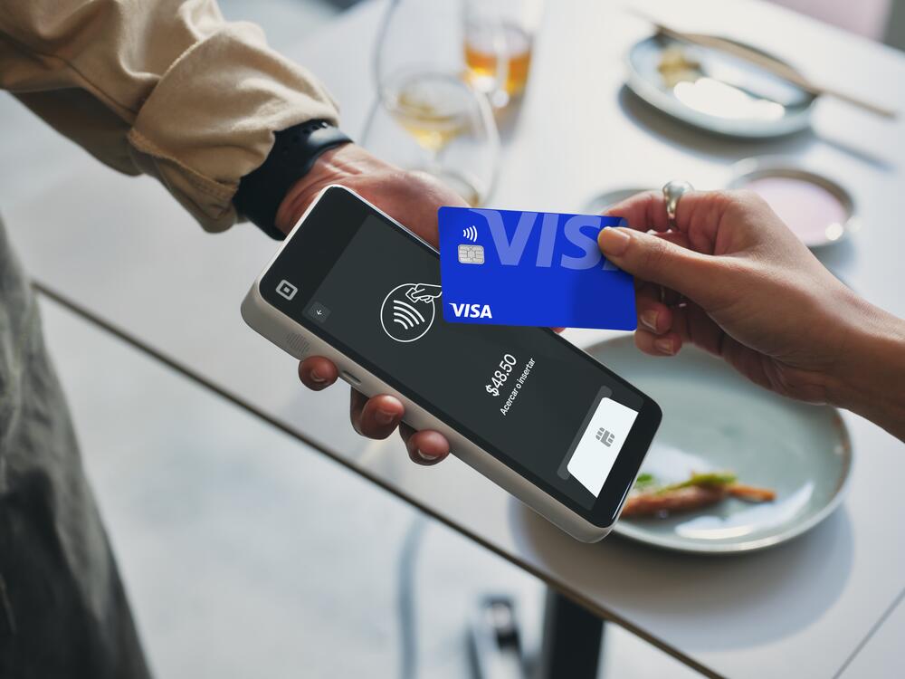 Restaurant operator using Square Handheld taking payments