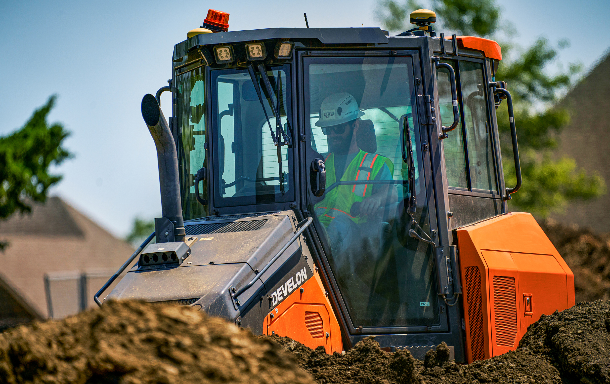 An operator working in the cab of a DEVELON dozer.