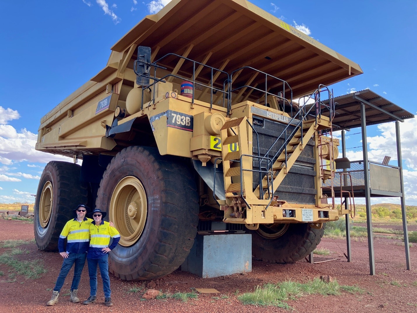 Image of Vocus team standing in front of a giant truck working on Project Horizon in Western Australian outback