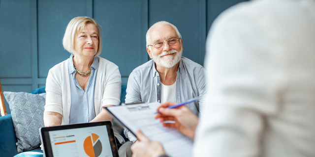 Senior couple with consultant at the office