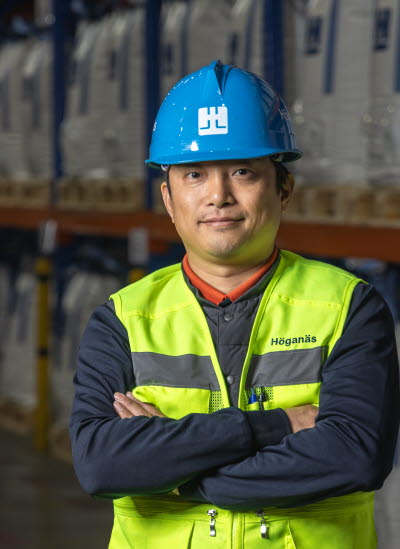Male co-worker in blue helmet and safety west