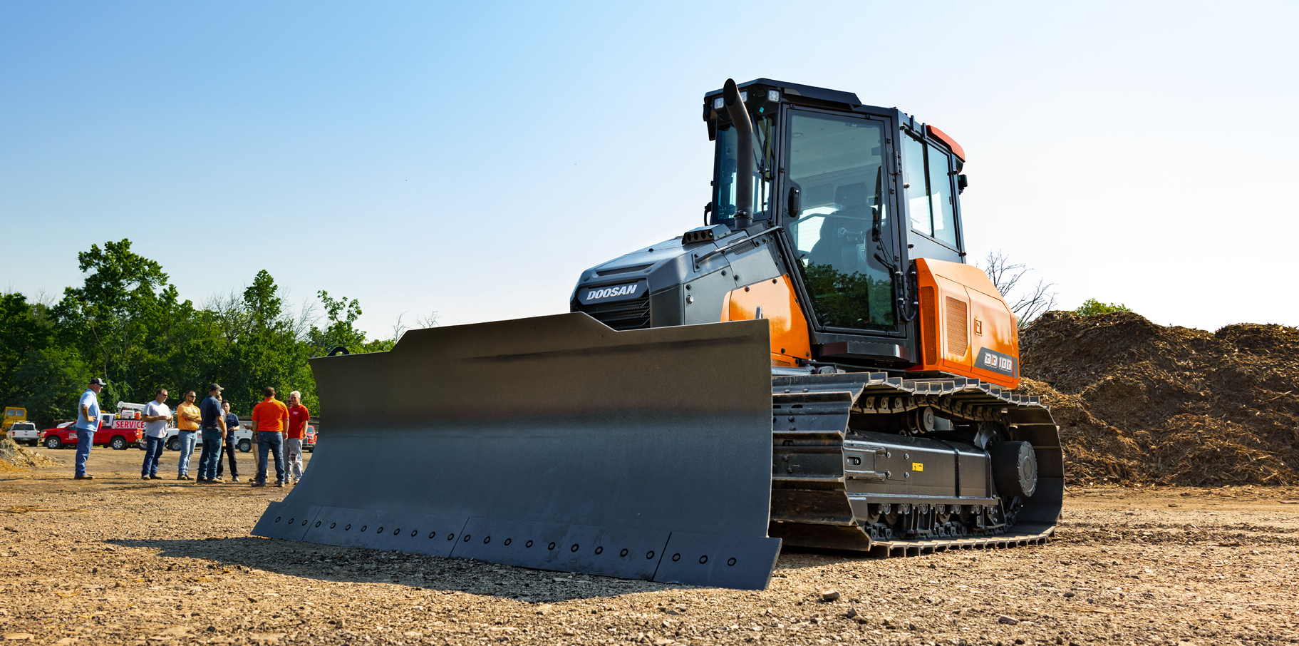 DEVELON DD100 dozer parked at a job site.