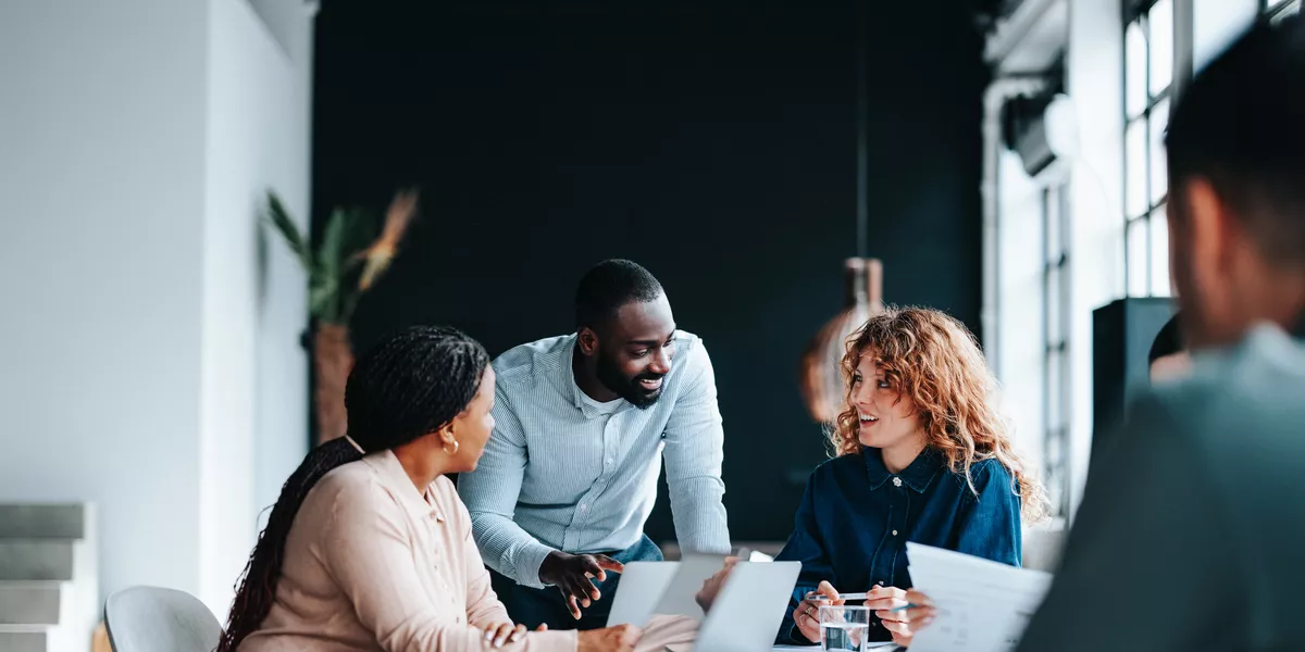 A group of colleagues working together in a contemporary office environment.