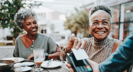 Senior woman making credit card payment 
