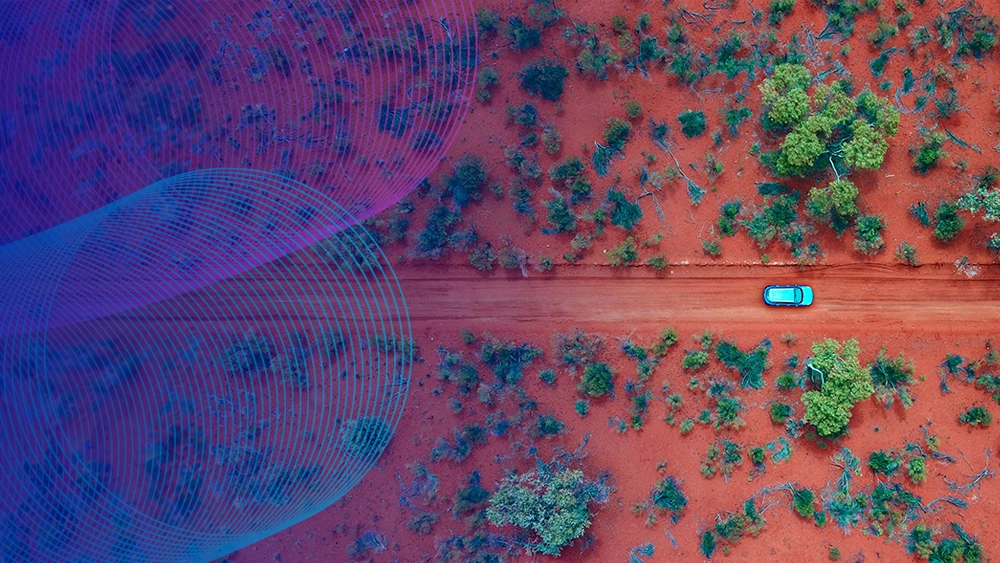 Stock image of a car driving through the Australian desert. Taken from above. Vocus slinky overlay.