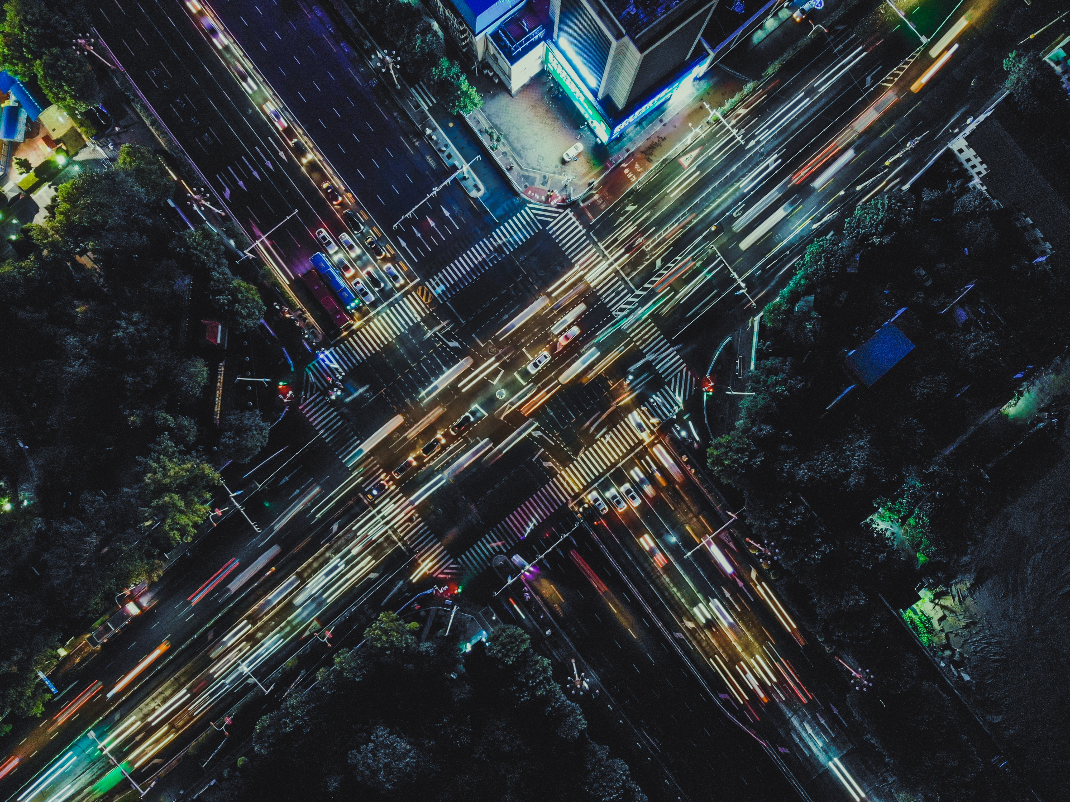 Picture of city at night from above. The traffic is blurred representing the busyness of life.
