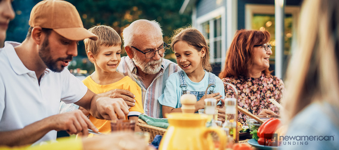 A happy multi-generational family enjoys a meal together