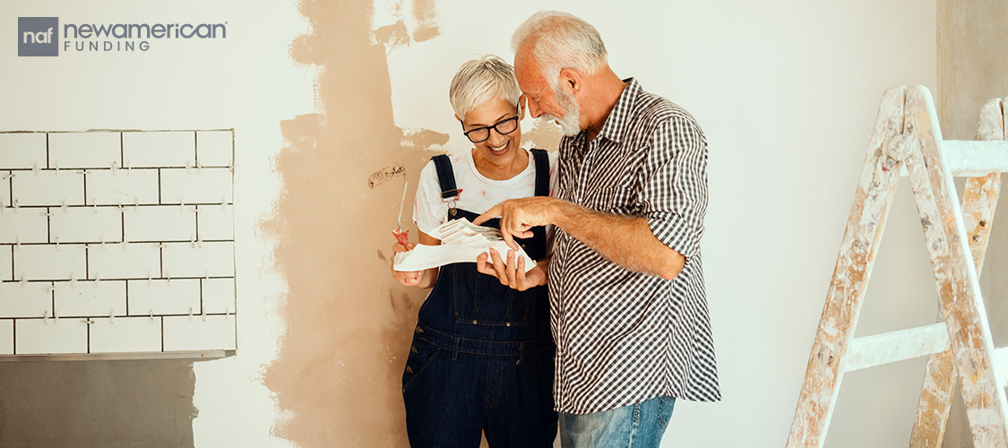 old loving couple going over renovation plans