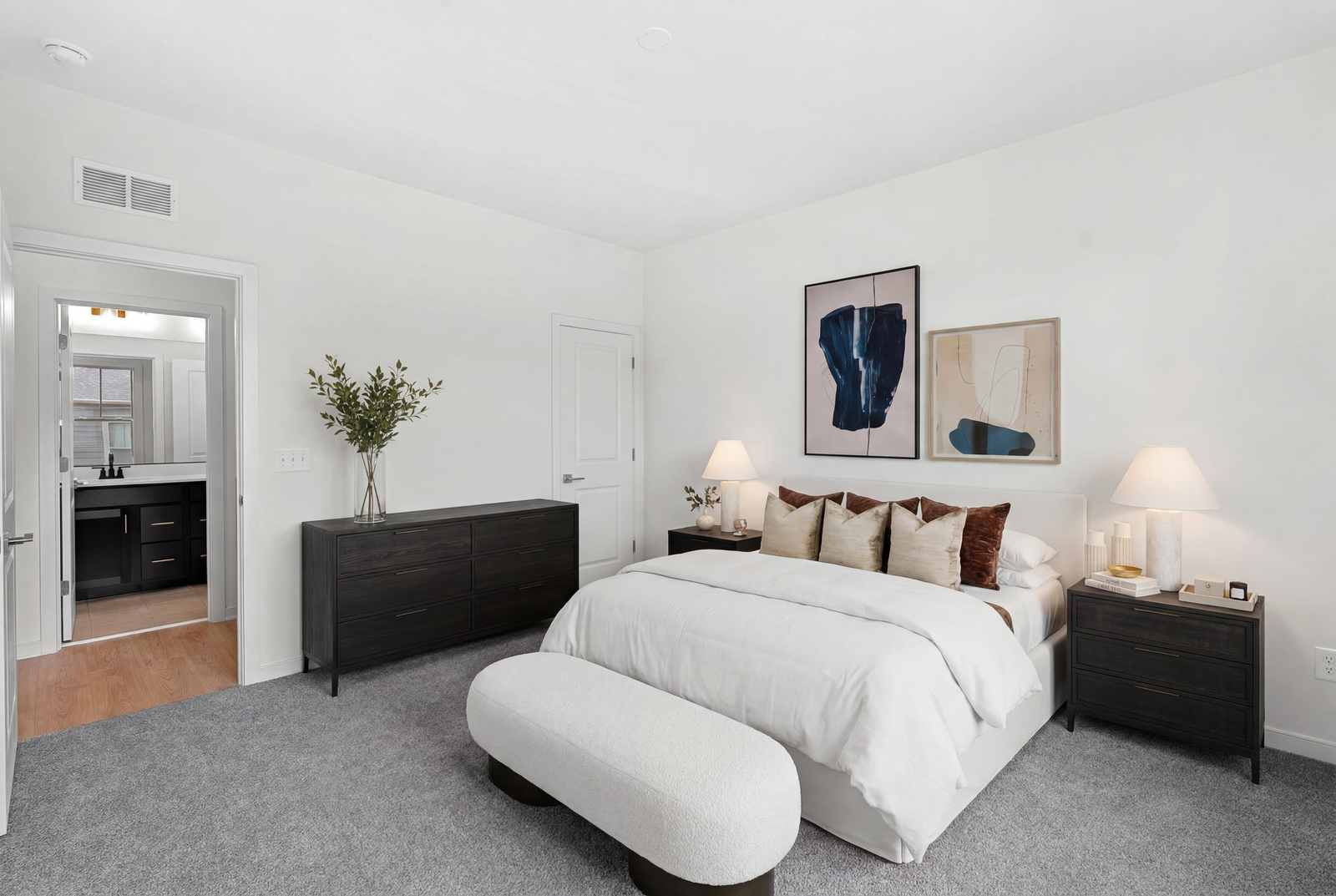 primary suite with large bed and cabinets