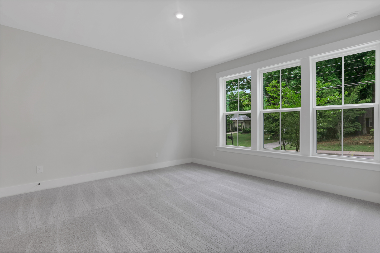 bedroom with windows and carpet