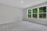 bedroom with windows and carpet