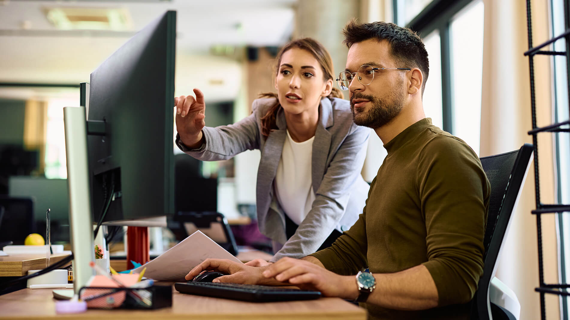 1902x1070_mascp-ccio-feature-page.jpg Man and woman looking at computer monitor.