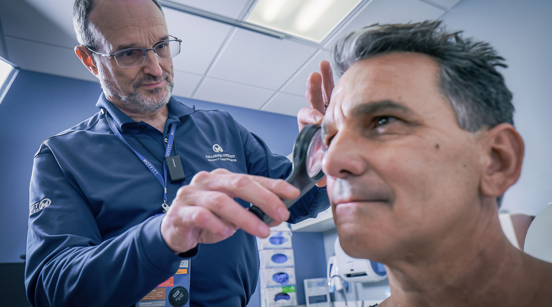 Dr. Vernon Sondak performs a skin check on patient