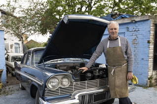 A man in front of a car