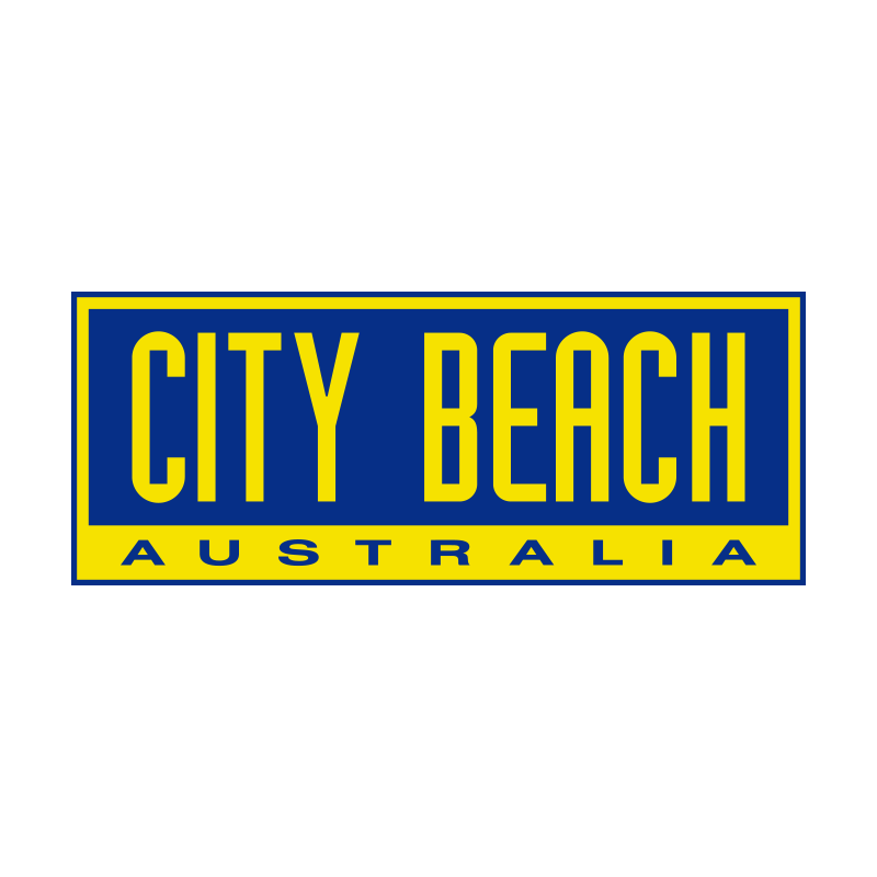 city beach, woman sitting on chair wearing white jeans strapless light blue top and black boots. male standing wearing black nike jumper blue jeans and white sneakers