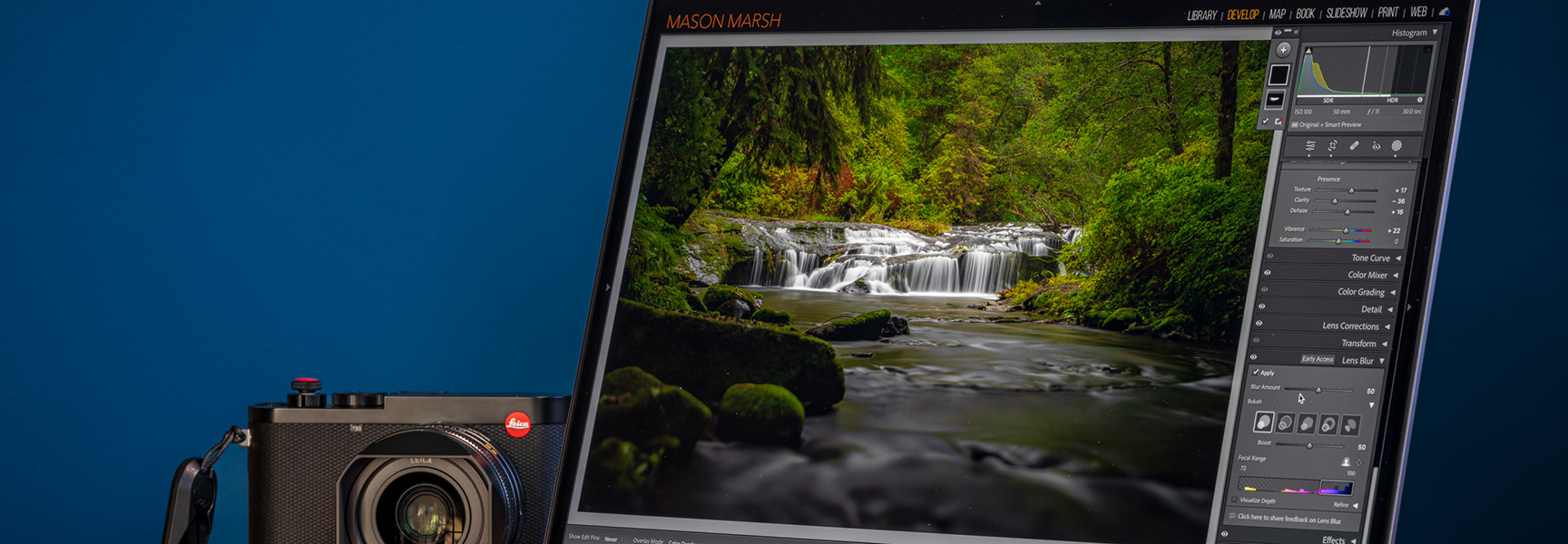 A photographer edits a photo of a waterfall in Ecuador on a laptop next to a Leica camera.
